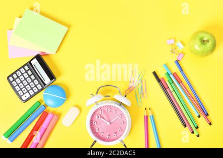 Fun school stationary scattered at the bottom on yellow background. Stock Photo