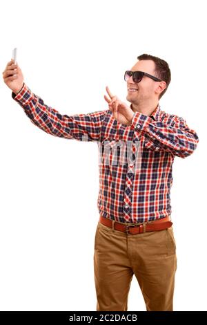 A portrait of a young fashionable man taking a selfie, isolated on white background. Stock Photo