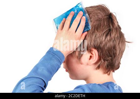 Child cools the forehead with a cold pack Stock Photo