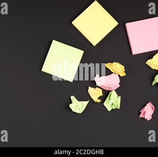 empty square multi-colored stickers hang on a black board in a wooden frame, business concept Stock Photo