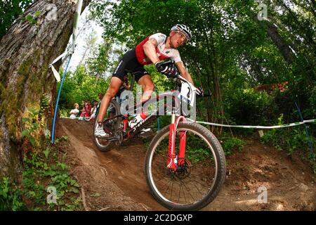VAL DI SOLE, ITALY - JUNE 22, 2008. . Christoph Sauser (SUI) on his way to winning the UCI Mountain BIke Cross Country World Championships Stock Photo