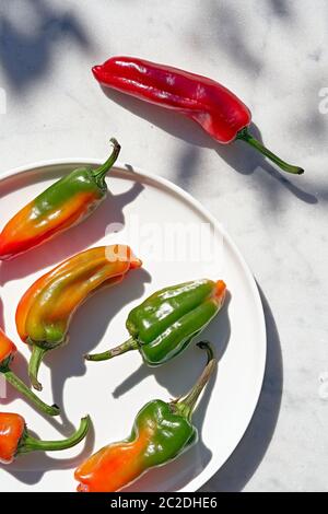 Yellow chili peppers, and a red chili pepper Stock Photo
