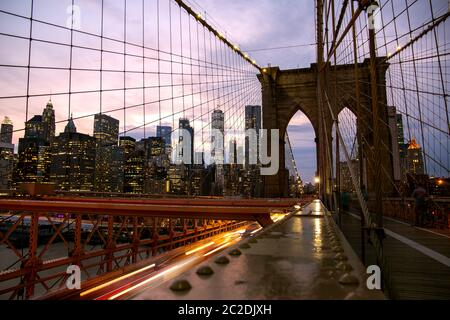 New York City / USA - JUL 10 2018: Lower Manhattan view from Brooklyn Bridge at sunset Stock Photo