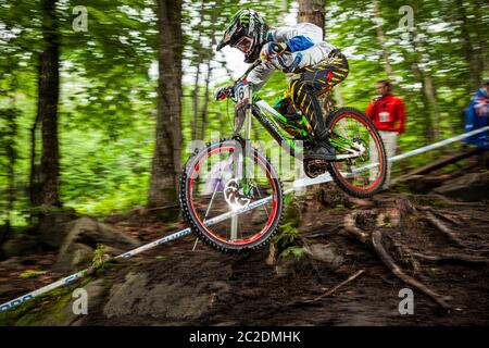MONT ST ANNE, CANADA - JULY 1, 2011. Troy Brosnan (AUS) racing for Team Specialized at the UCI Downhill Mountain Bike World Cup Stock Photo