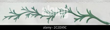 Relief of a green plant on a white wall Stock Photo