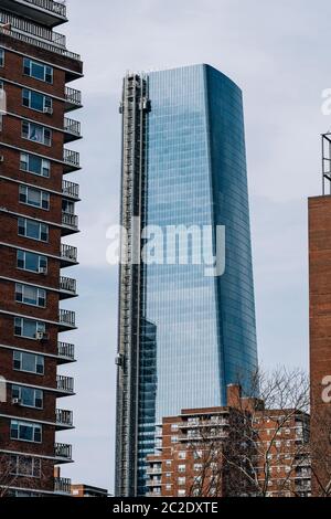 A view of 15 Hudson Yards through apartment buildings in Chelsea New York City