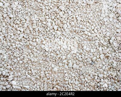 Background from white macadam for construction. Wall from granules stone Stock Photo
