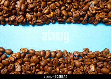 Texture of coffee beans. Roasted coffee beans background. close up Coffee beans with copy space on blue background Stock Photo