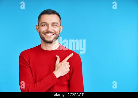 Handsome happy man pointing his finger showing empty copy space Stock Photo