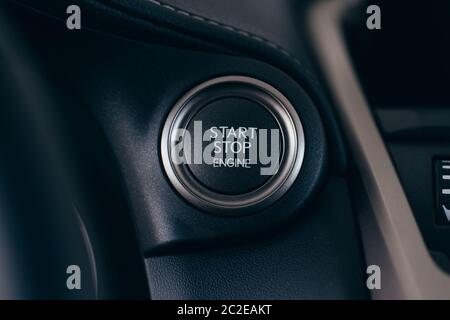Car start stop system with finger pressing the button, horizontal image Stock Photo