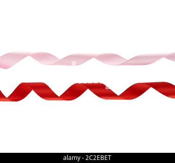 curled red and pink satin ribbons isolated on white background, festive backdrop Stock Photo