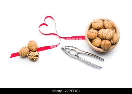 Three nuts a day for heart health, walnuts on bowl on white background Stock Photo
