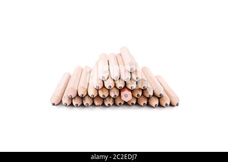 One makes a difference. Stack of pencils isolated on white background. One crayon among many pencils, turned in different direction. Stock Photo