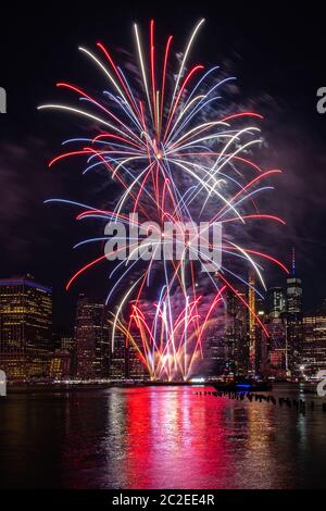 Macy's 4th of July Independence Day Fireworks show on east river with Lower Manhattan Skyline Stock Photo