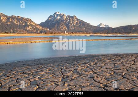 View over dry lake Forggensee to Neuschwanstein castle Stock Photo