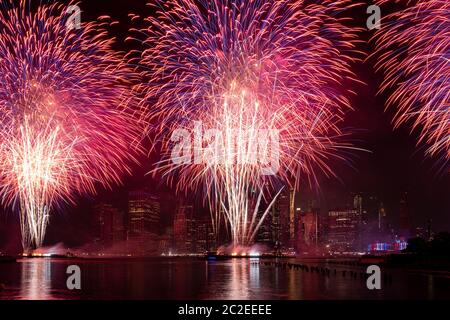 Macy's 4th of July Independence Day Fireworks show on east river with Lower Manhattan Skyline Stock Photo