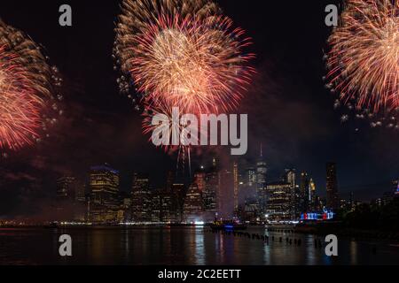 Macy's 4th of July Independence Day Fireworks show on east river with Lower Manhattan Skyline Stock Photo