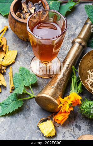 Mortar and bowl of raw and dried healing herbs.Assorted natural medical herbs Stock Photo