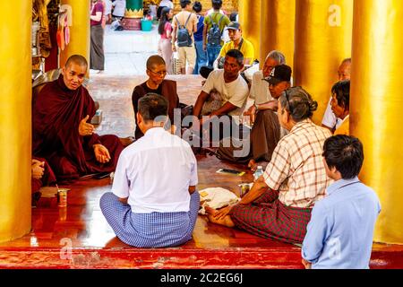 Monks Giving Advice To People At The Shwedagon Pagoda, Yangon, Myanmar. Stock Photo