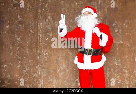 Santa Claus walking with the bag of the presents Stock Photo