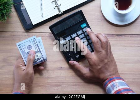 Man hand using calculator on office desk  Stock Photo