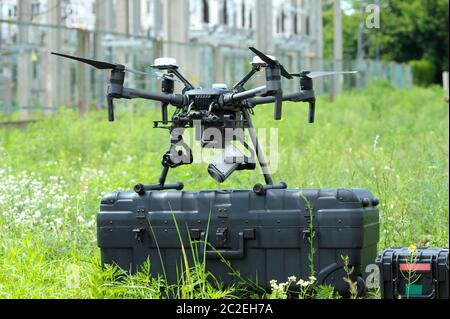 Pro quadcopter with camera and remote control placed on the box before adjusting Stock Photo