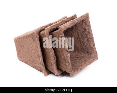 Three empty peat pots isolated on white background Stock Photo