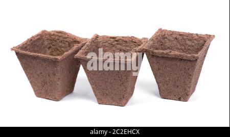 Three empty peat pots isolated on white background Stock Photo