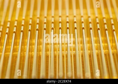 Background made of a golden radiator from a computer close up, modern design macro shot. Stock Photo