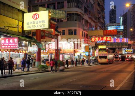 Hong Kong, China - January 4, 2012. Street scene at night in Kowloon, Hong Kong, China featuring the entrance to the landmark market street - Temple S Stock Photo