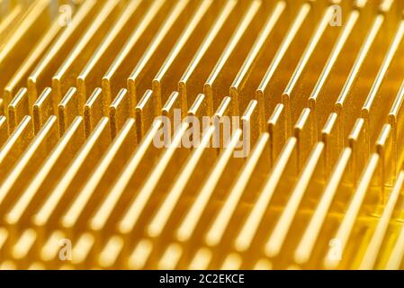 Background made of a golden radiator from a computer close up, modern design macro shot. Stock Photo