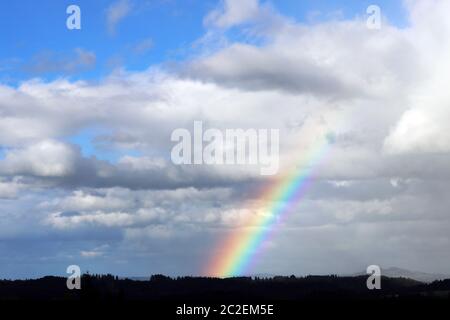 A beautiful colorful rainbow in the sky Stock Photo