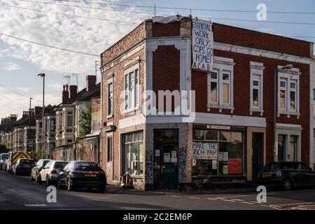 Dawn light falls on the inner-suburban terraced housing of Easton, including Kebele Community Co-op, decorated with political banners and posters, in Stock Photo