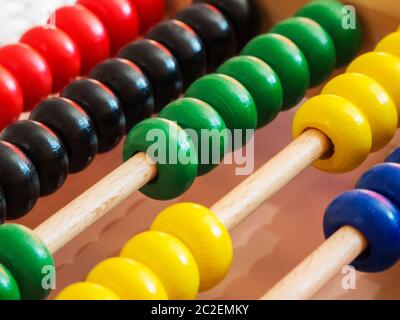 Close-up of a wooden abacus with colorful quills in an oblique view. Stock Photo