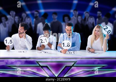 Group Of Upset Young Judges Giving Low Scores Stock Photo