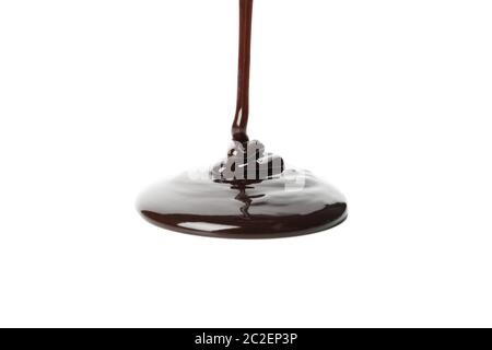 Melted chocolate is pouring, isolated on white background Stock Photo