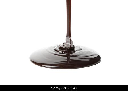 Melted chocolate is pouring, isolated on white background Stock Photo