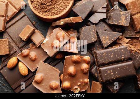 Chocolate, melted chocolate and almond on black background Stock Photo