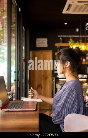 girl having coffee while working in a cozy environment Stock Photo