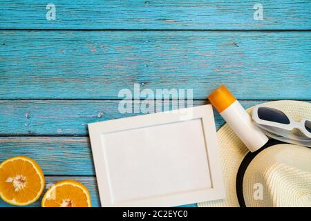 Beautiful summer holiday, Beach accessories, orange, sunglasses, hat and sunblock on wooden backgrounds Stock Photo