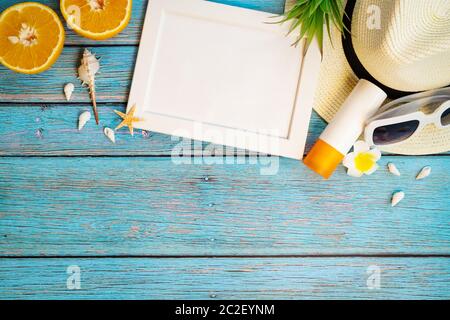 Beautiful summer holiday, Beach accessories, orange, sunglasses, hat and sunblock on wooden backgrounds Stock Photo