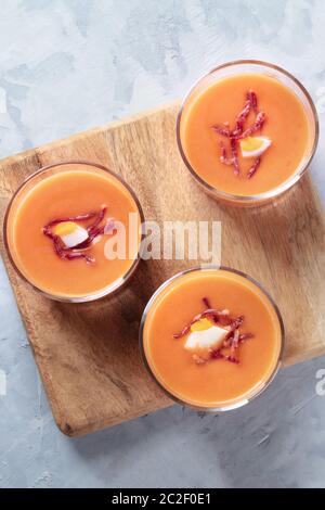Salmorejo, Spanish cold tomato and bread soup, served in glasses, overhead close-up shot with a place for text Stock Photo