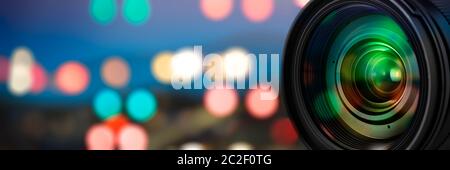 Camera lens with reflections on blur background Stock Photo