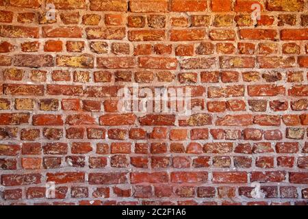 Weathered texture of stained old dark brown and red brick wall background, grungy rusty blocks of stone-work technology, colorfu Stock Photo