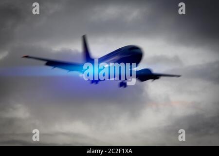 plane in the sky motion blur with blue light flare Stock Photo