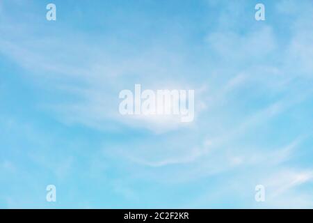 Abstract background of a vibrant clear blue turquoise sky with soft white clouds Stock Photo