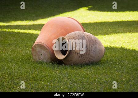 ancient vases lying on the lawn for art Stock Photo