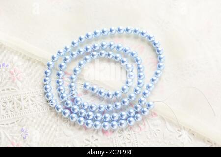 pearl necklace on white fabric background, Close up shot of glass pearls Stock Photo