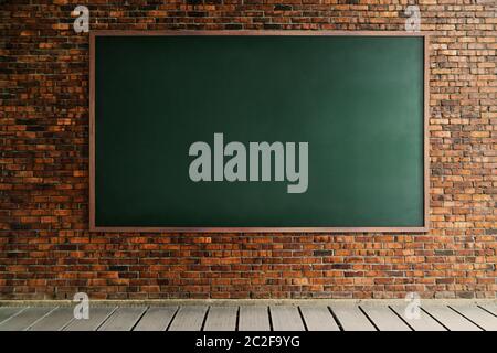 Square black chalk board texture empty blank with wooden frame. brick wall with cement floor . Stock Photo