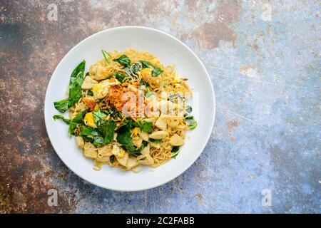 Fried noodles with Vietnamese Grilled Pork Sausage, eggs and Gnetum gnemon leaves Stock Photo